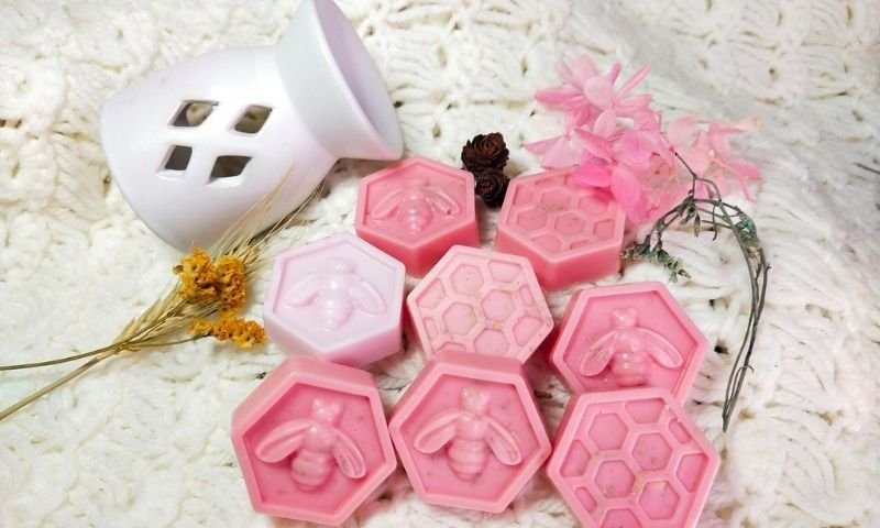 Jabones artesanales con forma de panal y abeja, ejemplo del taller de velas y jabones naturales